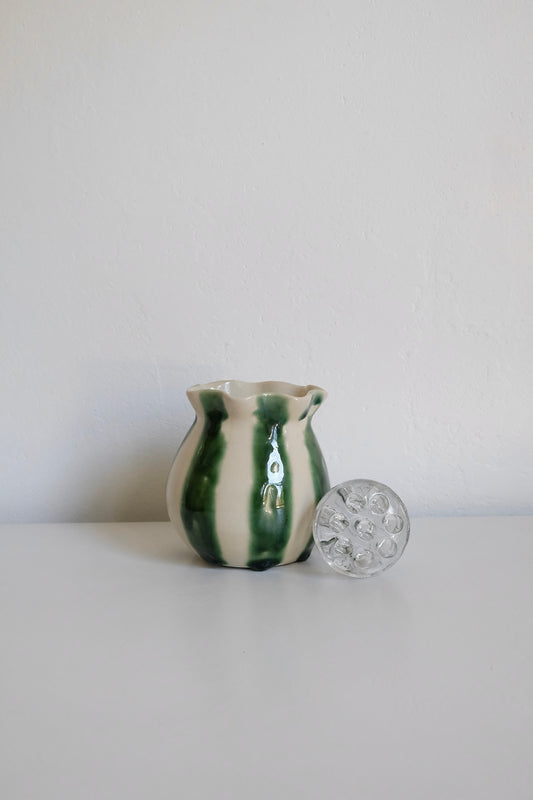 striped vase with glass flower frog