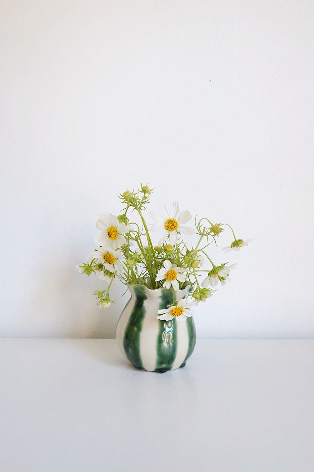 striped vase with glass flower frog