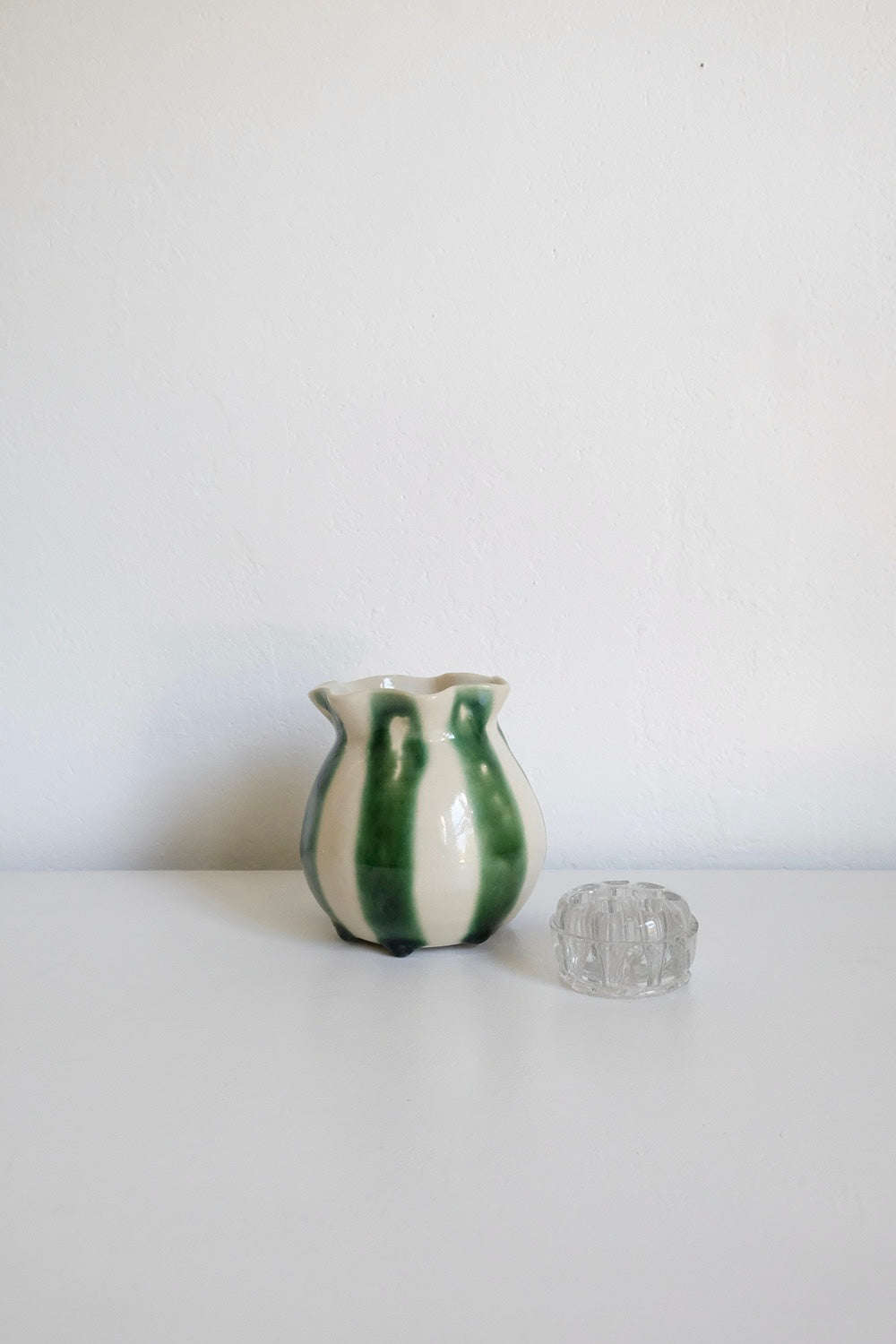 striped vase with glass flower frog