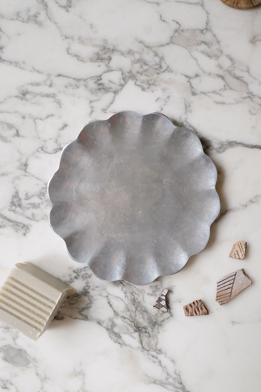 scalloped metal dish