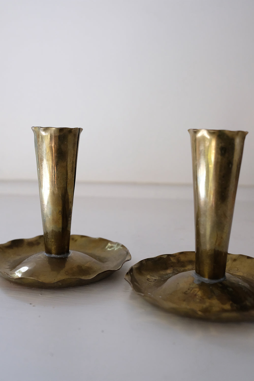 brass skirted candlesticks - set of 2