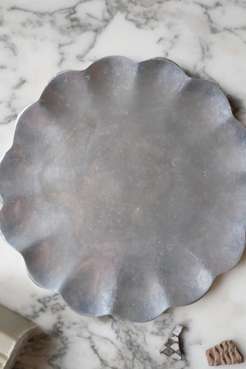 scalloped metal dish